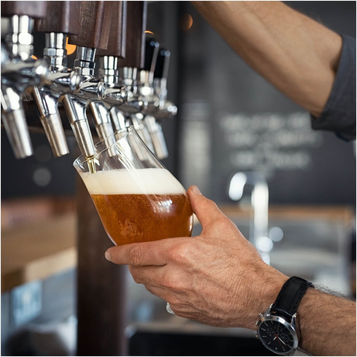 Temporary bar staff tapping beer